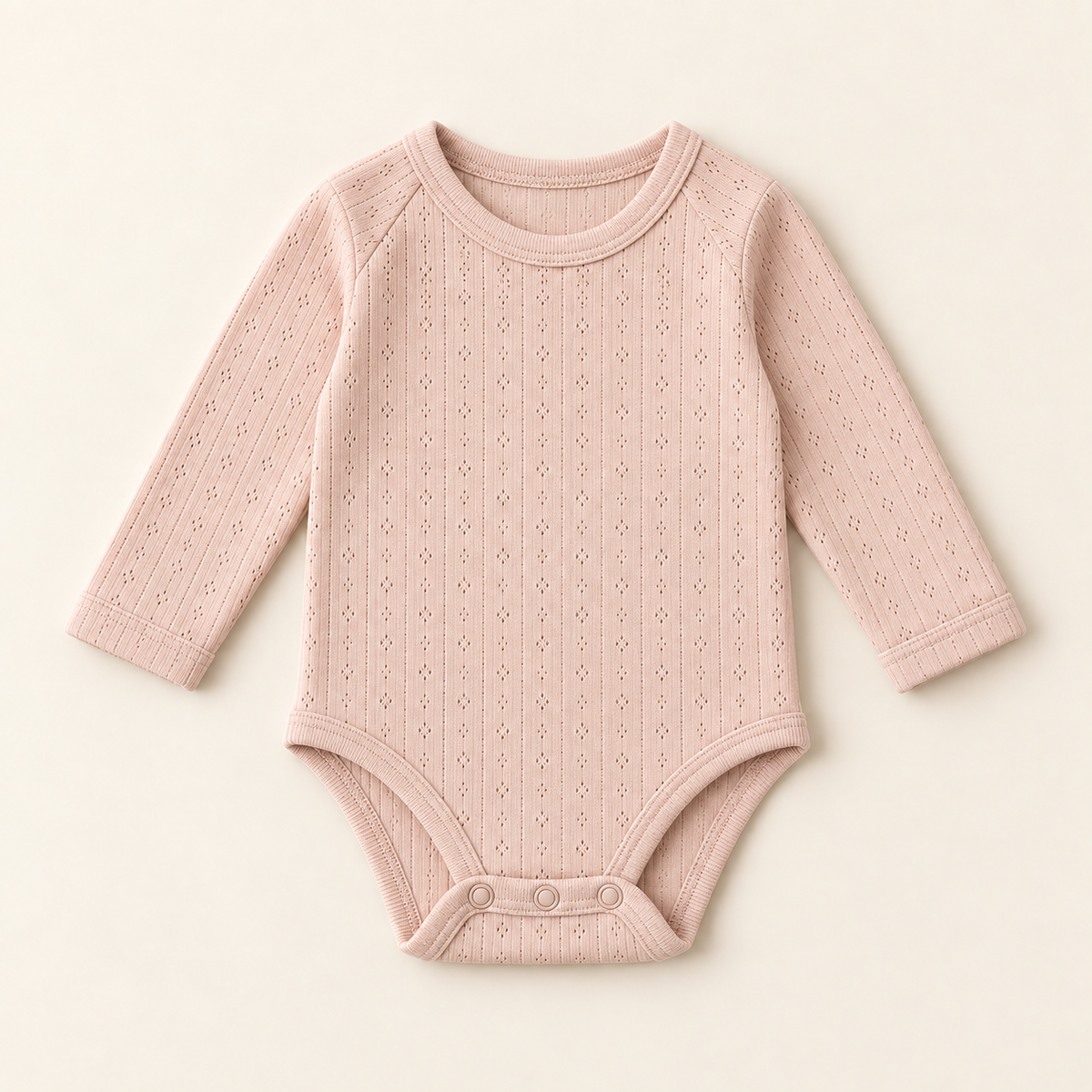 Blush pointelle long sleeve bodysuit with an openwork diamond knit and envelope neckline, laid flat.